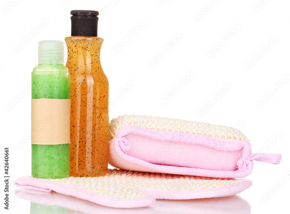 Bottles with scrub and sponges isolated on white Bottles with scrub and sponges isolated on white