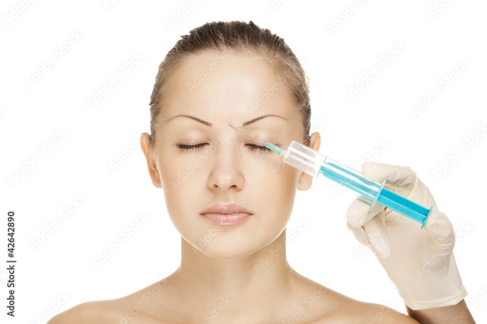 attractive young woman receives an botox injection attractive young woman receives an botox injection