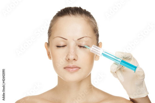 attractive young woman receives an botox injection 