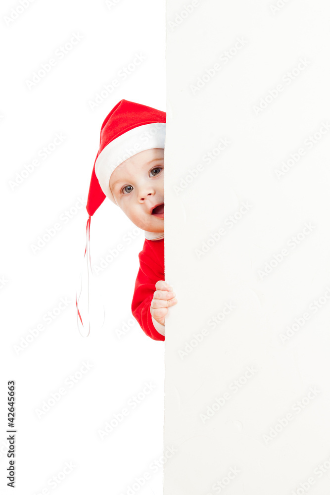 small Santa claus child looking from behind the placard small Santa claus child looking from behind the placard