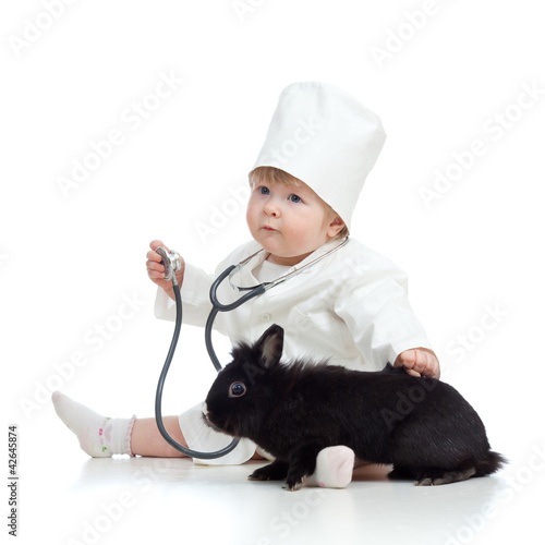 Cute child doctor with pet ...