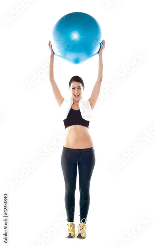 Gorgeous fit lady holding pilate ball © stockyimages