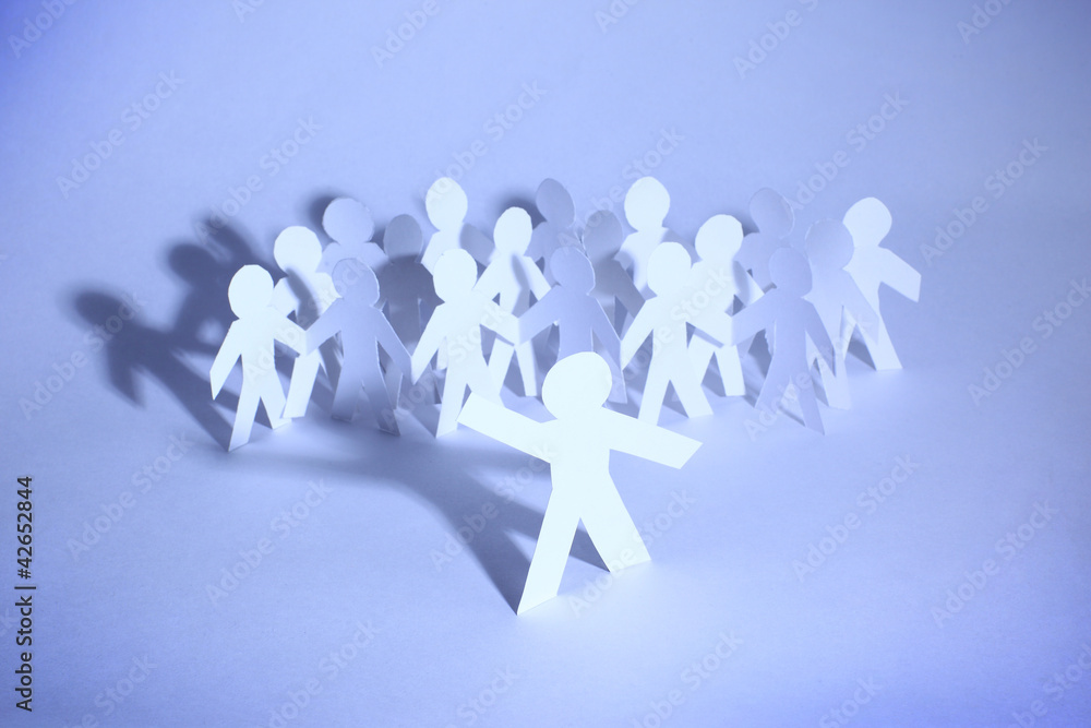A group paper people holding hands indicating community support A group paper people holding hands indicating community support