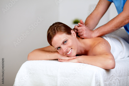 Young female getting a back massage by a masseuse
