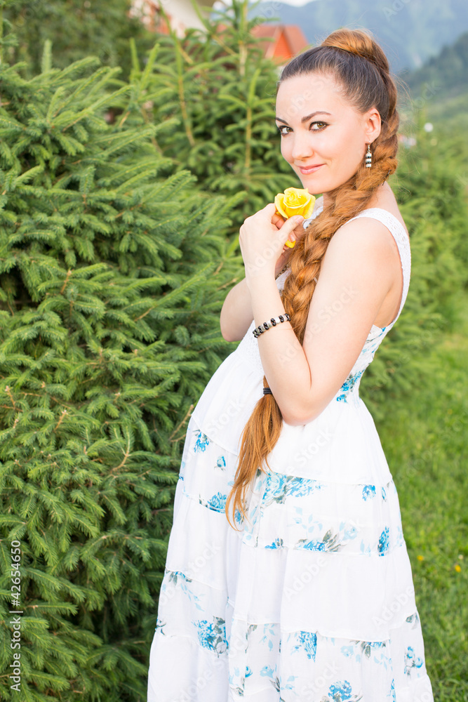 pregnant woman with yellow flower rose on nature pregnant woman with yellow flower rose on nature