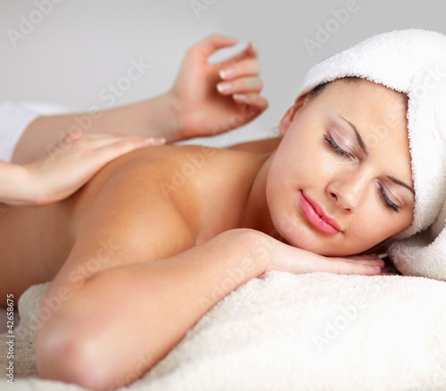 Relaxing massage for young beautiful woman in the spa salon