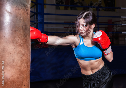 young and fit female fighter posing in combat poses
