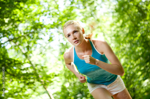 Woman Running Outdoors in Forest