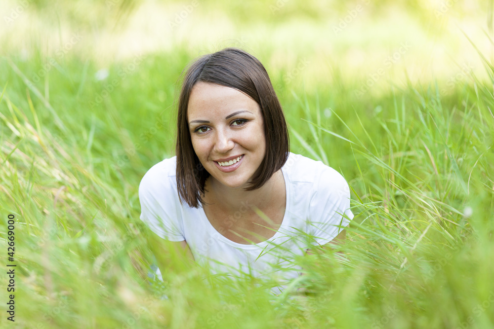 Beautiful teen girl in the park at green grass. Beautiful teen girl in the park at green grass.