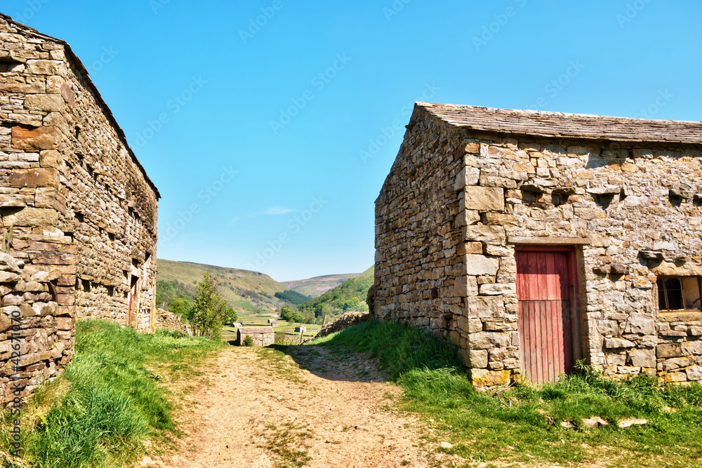 Farm track between two stone barns