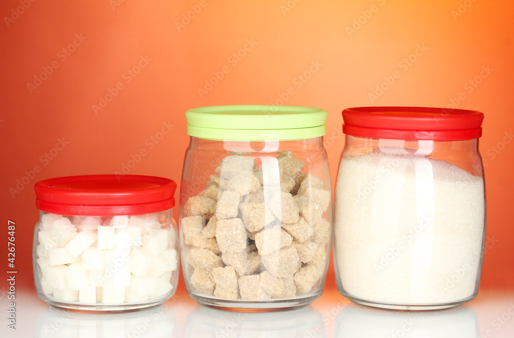 Jars with brown cane sugar lump, white crystal sugar and white Jars with brown cane sugar lump, white crystal sugar and white