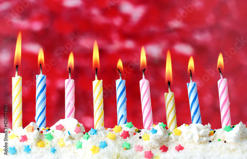 beautiful birthday candles on red background