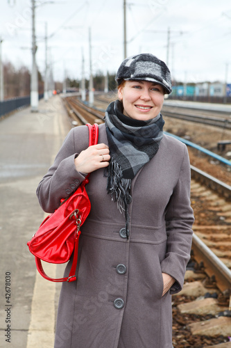 Portrait of happy fashion young woman in coat and cap