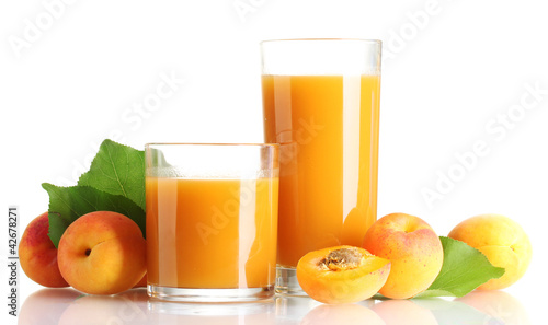 two glasses of apricot juice and apricots with leaves isolated