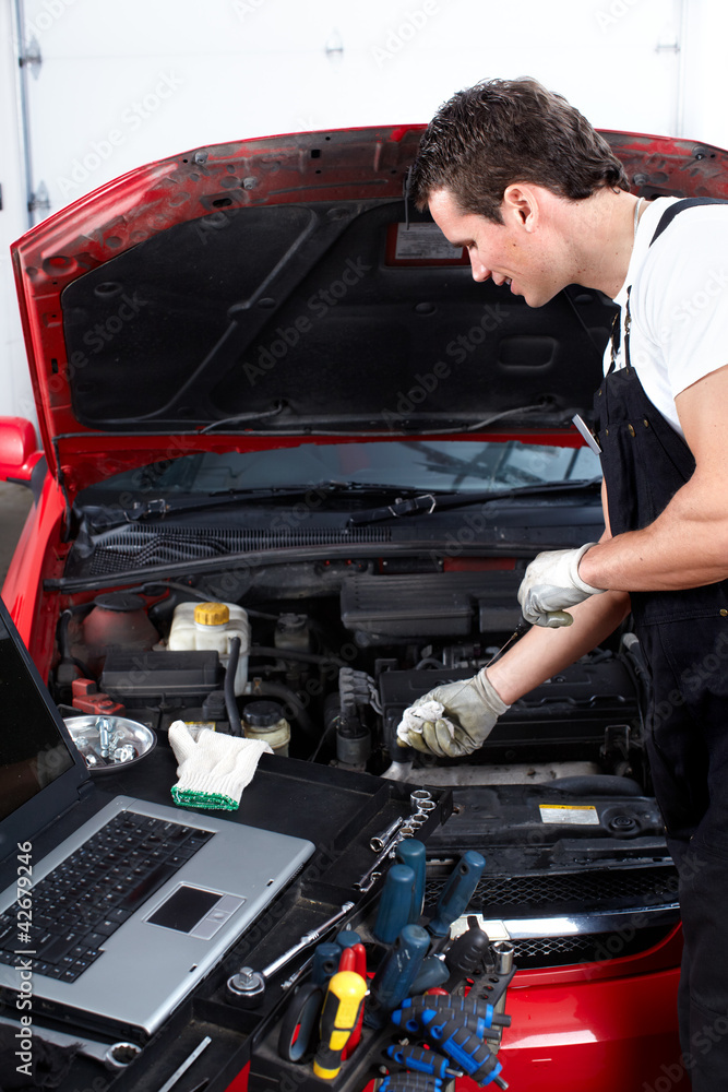 Auto mechanic checking oil. Auto mechanic checking oil.