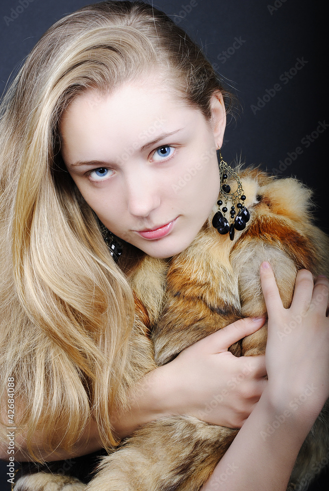 The beautiful girl against a dark background blue eyes The beautiful girl against a dark background blue eyes