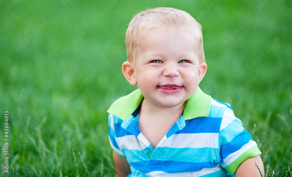 funny little boy over green grass funny little boy over green grass