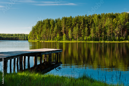 Wooden pier and forest on lake