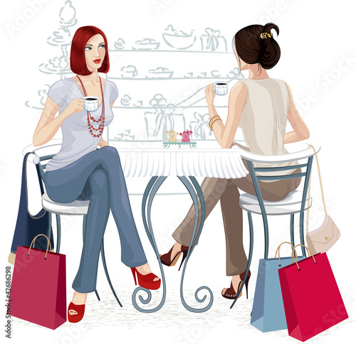 Two women sitting with cups of coffee at the table