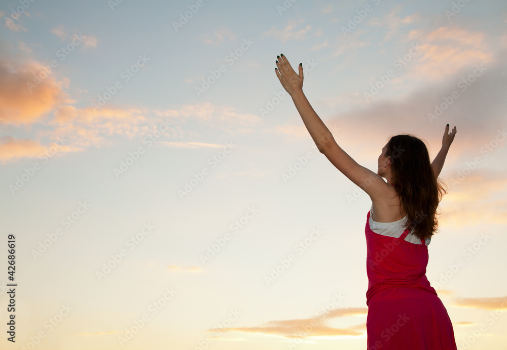 Woman staying with raised hands