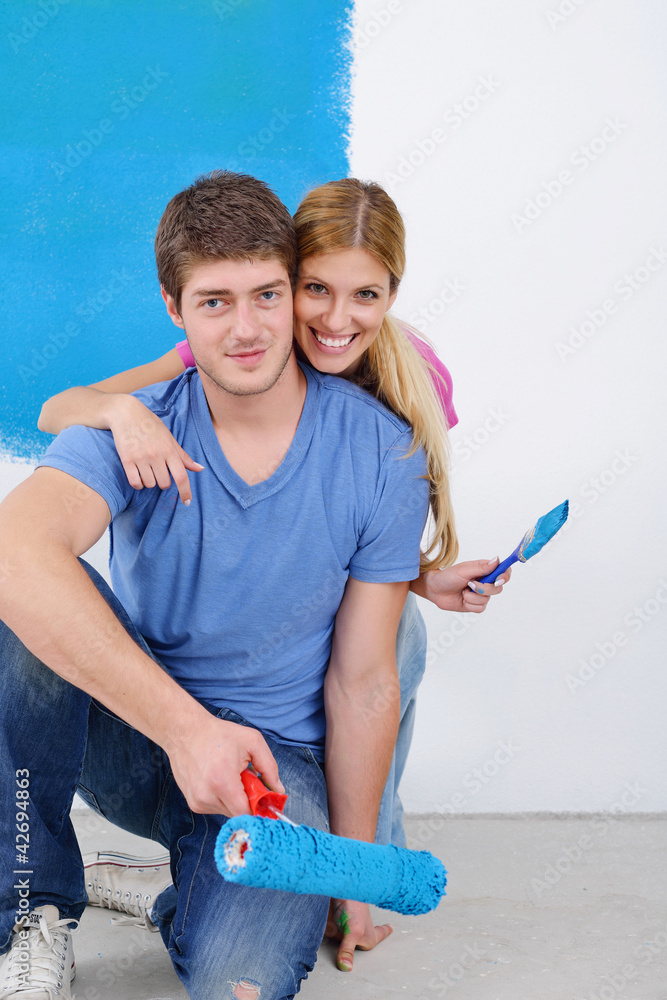 happy couple paint wall at new home happy couple paint wall at new home