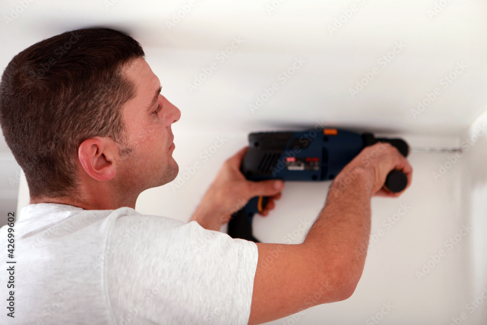 Laborer using drill Laborer using drill