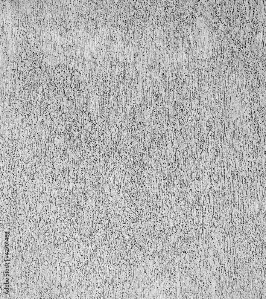 Fototapeta premium A close-up view of a rough gray concrete wall texture, showing a weathered and uneven surface suitable for use as a grunge background.