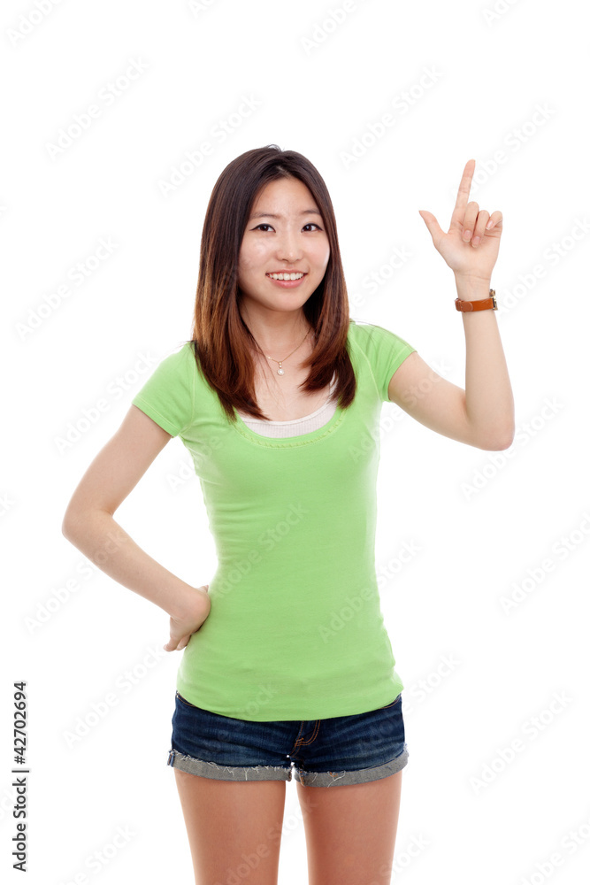 Smiling Asian woman pointing up Smiling Asian woman pointing up