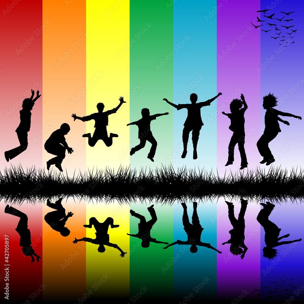 Group of children jumping over a rainbow striped background