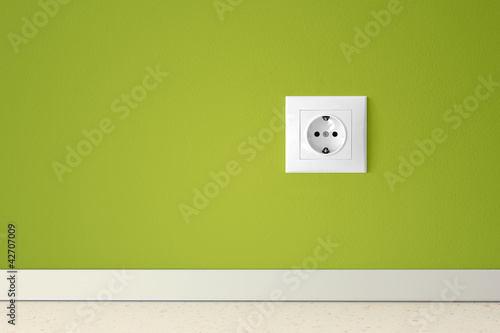 Green wall with european electric outlet photo