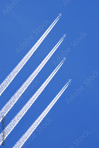 four jet airplanes in the sky