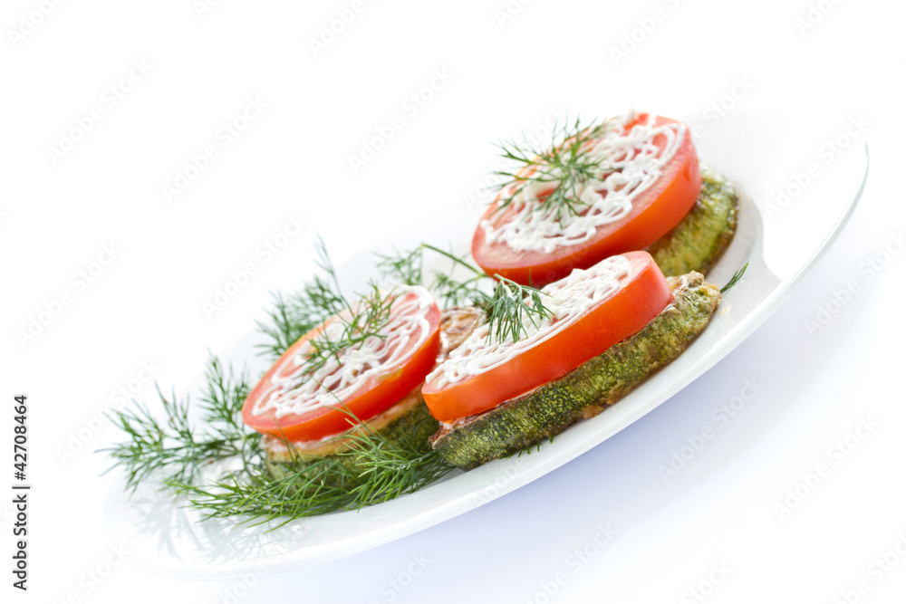 Fried zucchini with fresh tomatoes