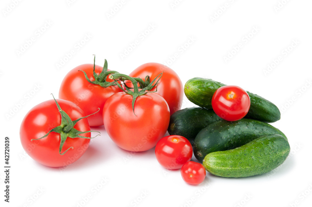 Close-up of ripe tomatoes and cucumbers, white background Close-up of ripe tomatoes and cucumbers, white background
