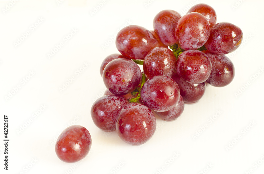 Close up of red grapes on white background