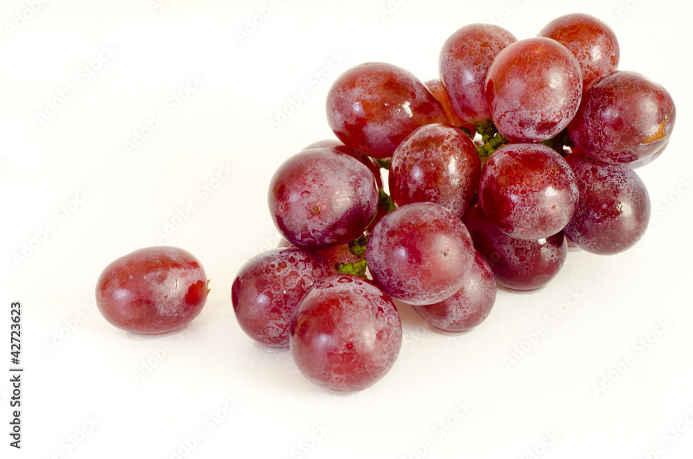Close up of red grapes on white background Close up of red grapes on white background