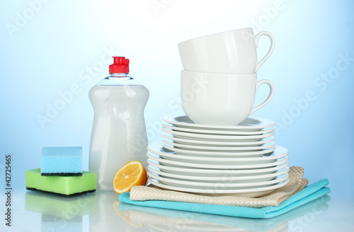 empty clean plates and cups with dishwashing liquid