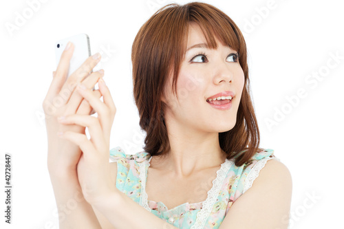 Beautiful young woman using a mobile phone. Portrait of asian.