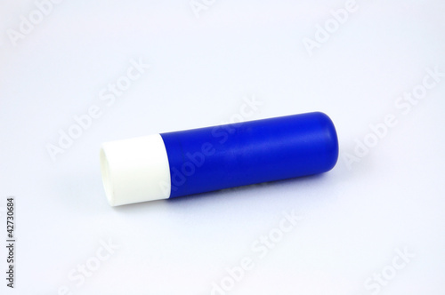 Blue tube of lip balm isolated on white background