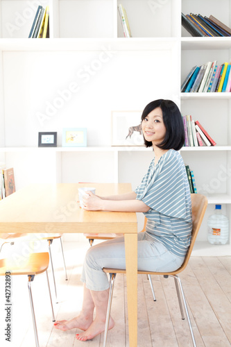 a young asian woman relaxing in the room