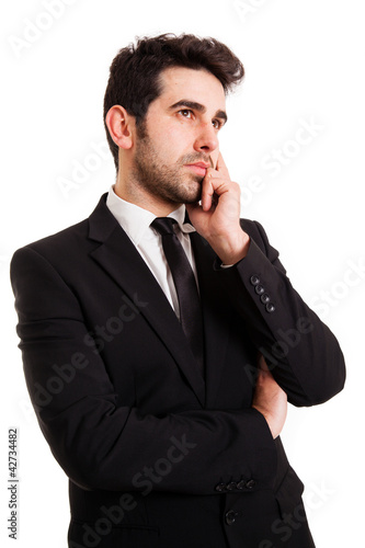 Young handsome man in black suit thinking, isolated on white