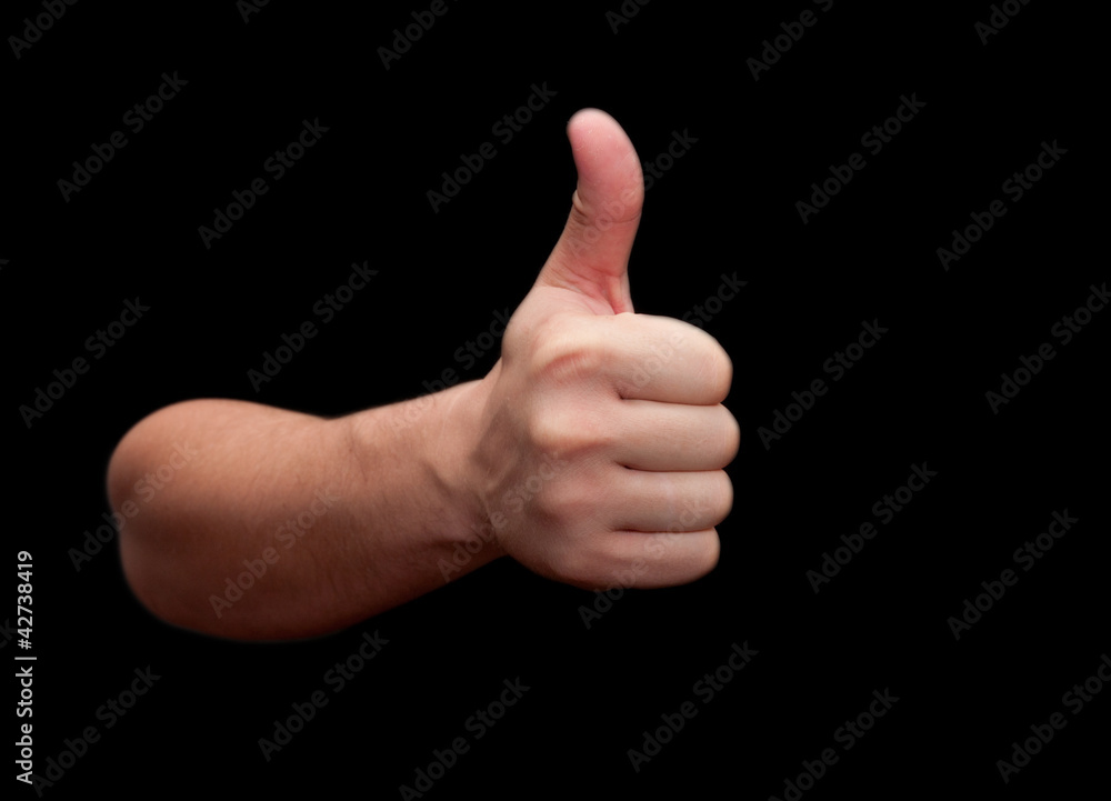 Thumbs up hand isolated on black background