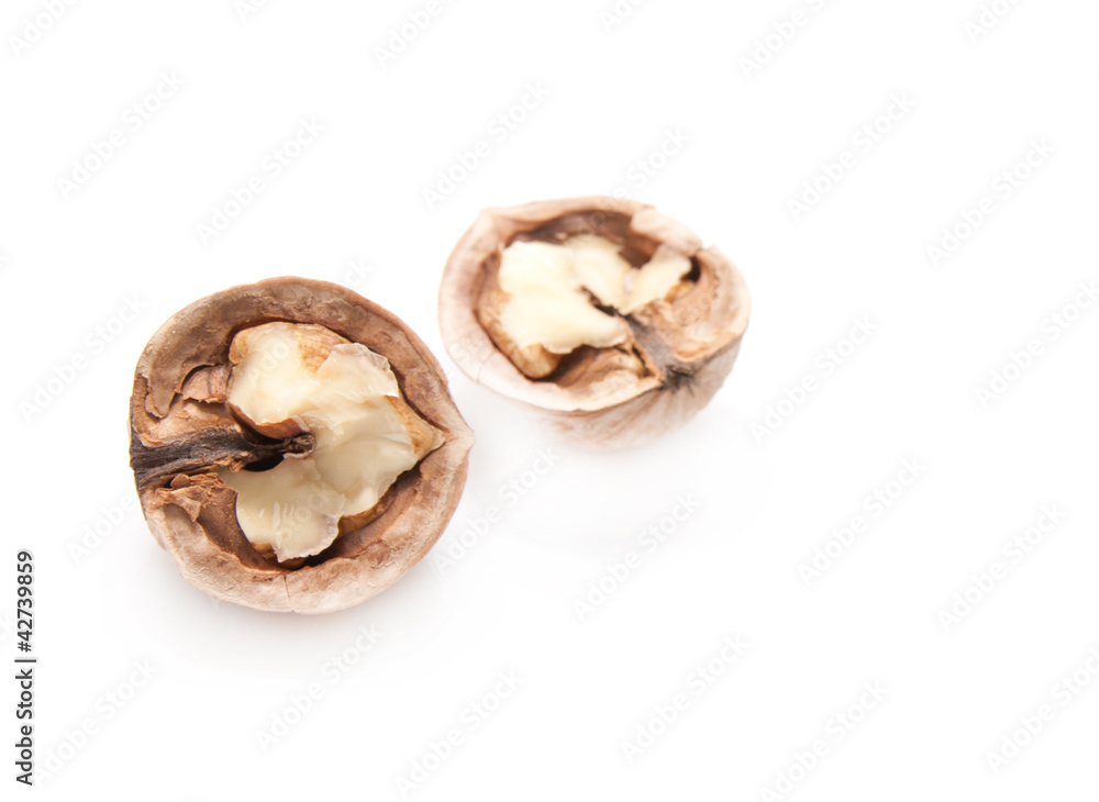 walnut and a cracked walnut isolated on the white background walnut and a cracked walnut isolated on the white background