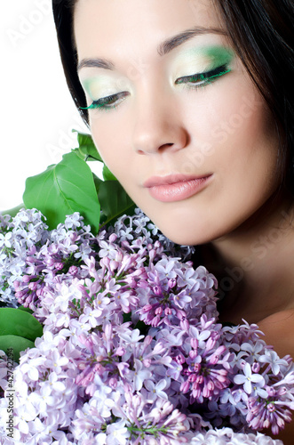 Beautiful woman with spring flowers of a lilac. Skincare © Vladimir Voronin