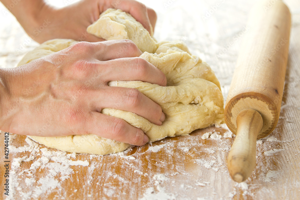 Housewife knead the dough for donuts with hands Housewife knead the dough for donuts with hands