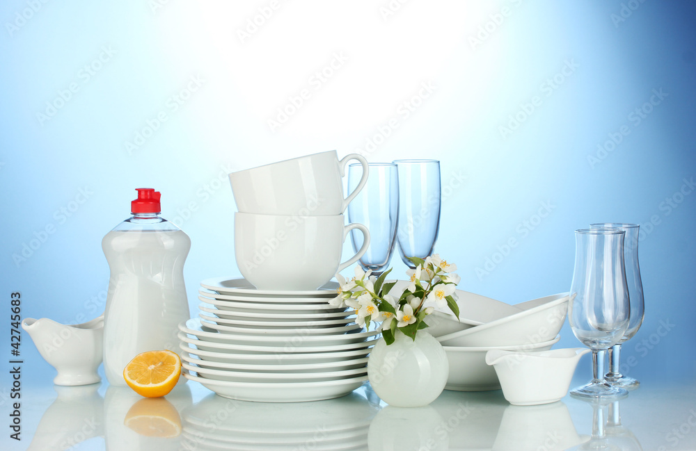 empty clean plates, glasses and cups with dishwashing liquid empty clean plates, glasses and cups with dishwashing liquid