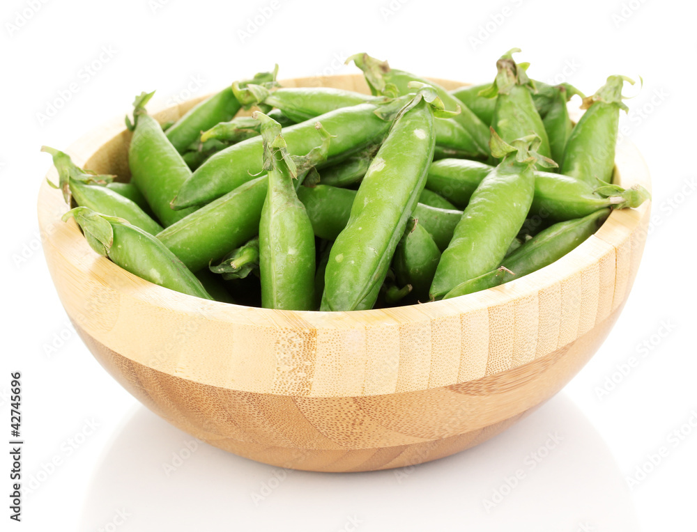 Green peas in wooden bowl isolated on white Green peas in wooden bowl isolated on white