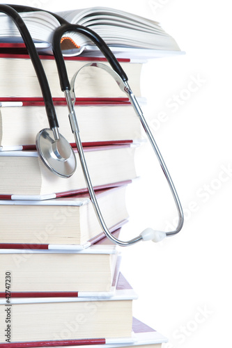 Obraz na plátně Stack of books and a stethoscope medical on a white background.