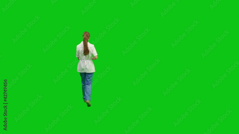 Young nurse moves around with a report. Green screen. Young nurse moves around with a report. Green screen.