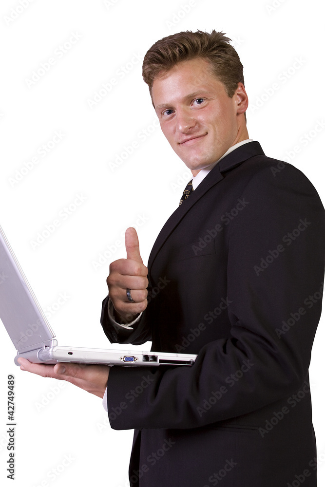 Businessman working on laptop and gesturing with thumbs up Businessman working on laptop and gesturing with thumbs up