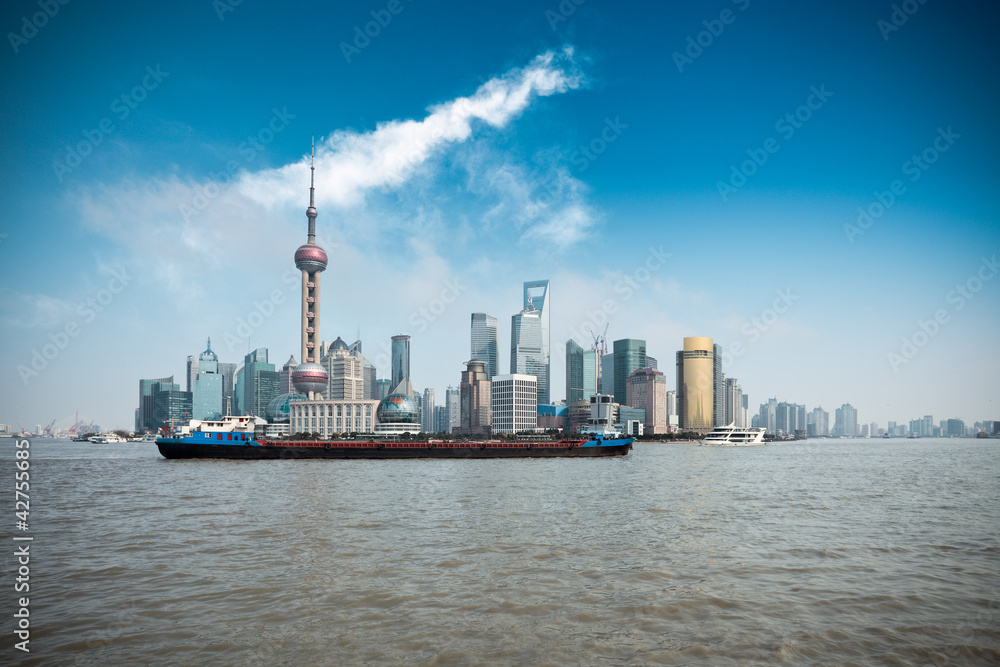 shanghai skyline and a cargo ship